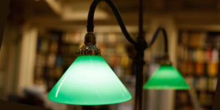 Green library lamps in an antique gas light style converted to electric