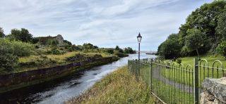 Image of the River Erne flowing out to the Atlantic in Ballyshannon with a ruined mill in the distance