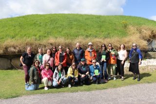 Group of RIA staff at posing for a photograph at Knowth passage tomb