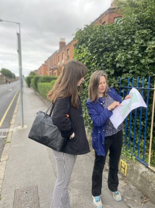 Ruth McManus showing Alison Roche a site on a map, standing on a footpath