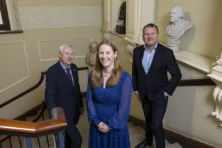 Martin Curley MRIA, Norma Bargary and Danny McCoy pictured on the steps of the Royal Irish Academy beside William Rowan Hamilton's bust